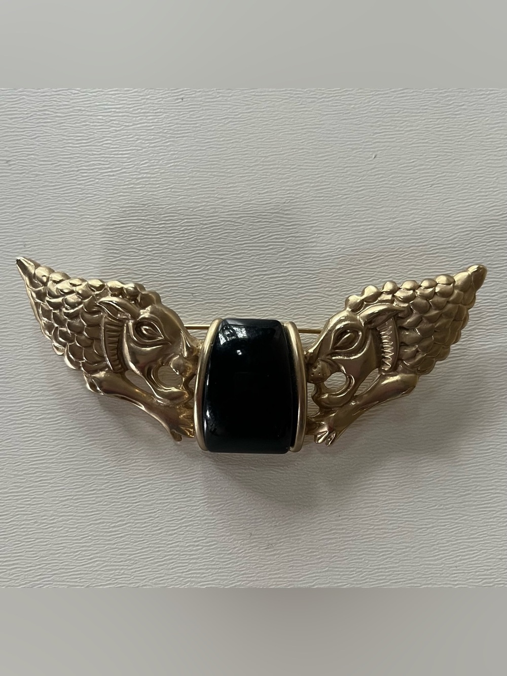 Large vintage Etruscan Revival style lion brooch with black stone.
